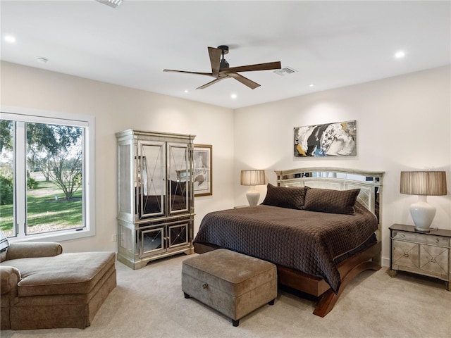 bedroom with ceiling fan and light colored carpet