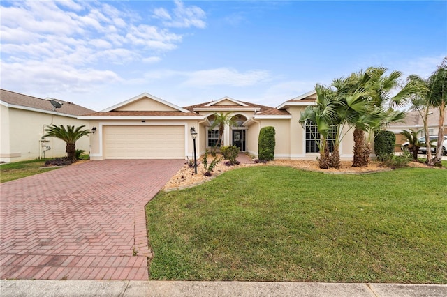 mediterranean / spanish-style home with a front yard and a garage