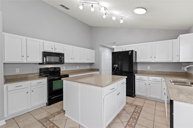 kitchen featuring sink, black appliances, white cabinets, a center island, and light tile patterned flooring