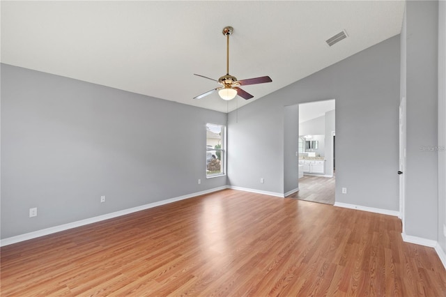 unfurnished room featuring light wood-type flooring, vaulted ceiling, and ceiling fan