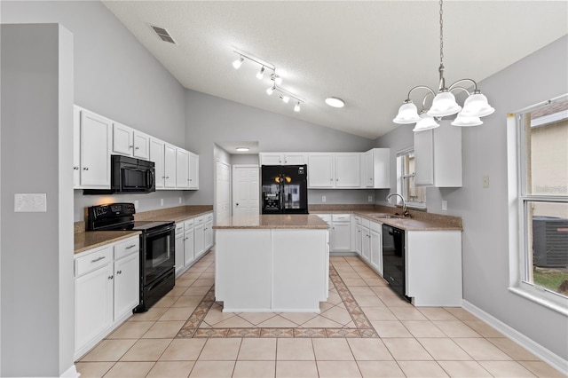 kitchen featuring a center island, white cabinets, black appliances, and decorative light fixtures