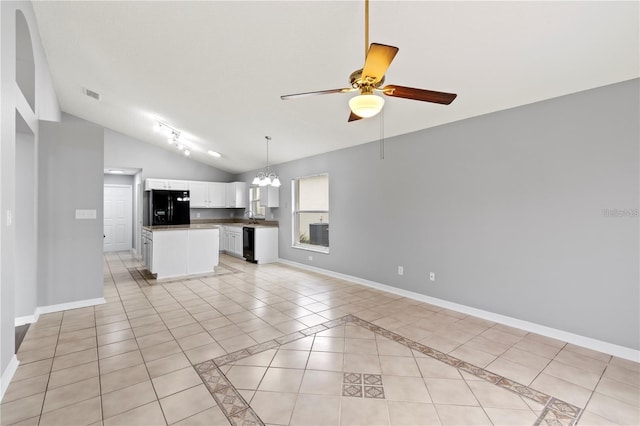 unfurnished living room with ceiling fan with notable chandelier, light tile patterned flooring, sink, and vaulted ceiling