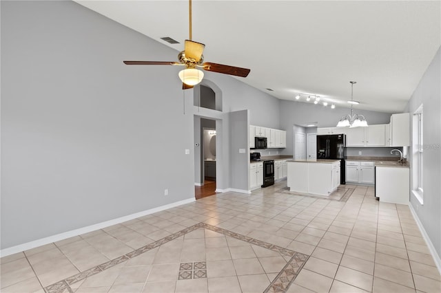 kitchen with black appliances, ceiling fan with notable chandelier, sink, a kitchen island, and white cabinetry