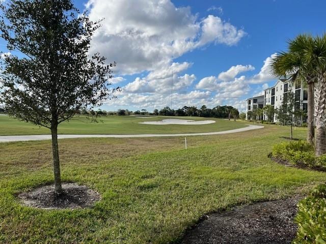 view of property's community with a lawn