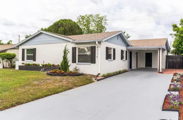 ranch-style house with a front yard and a carport