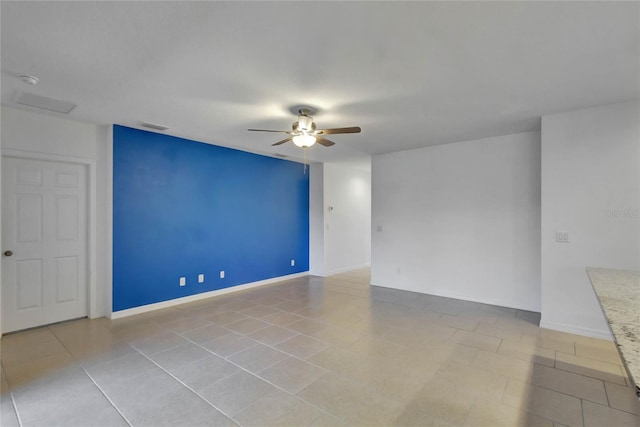 unfurnished room with ceiling fan and light tile patterned floors