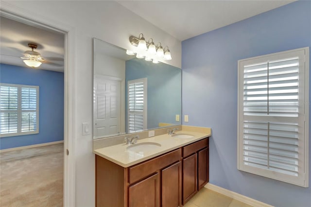 bathroom featuring tile patterned floors, vanity, and ceiling fan