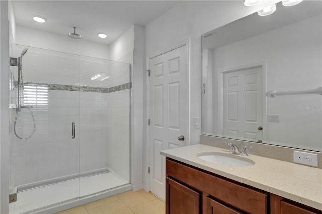 bathroom featuring tile patterned flooring, vanity, and an enclosed shower