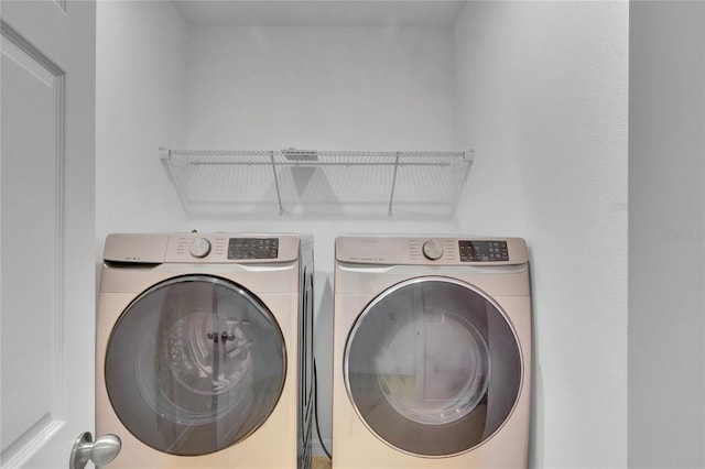 laundry room with washing machine and clothes dryer