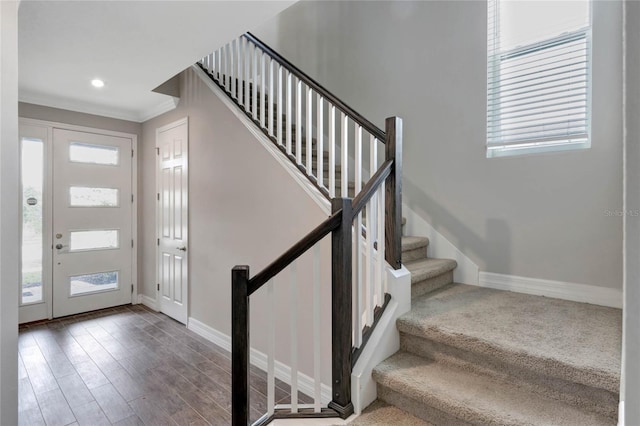 entryway featuring hardwood / wood-style flooring and crown molding