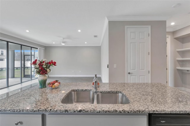 kitchen with light stone countertops, ornamental molding, ceiling fan, sink, and black dishwasher