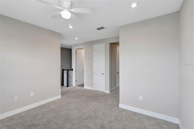 carpeted empty room with ceiling fan