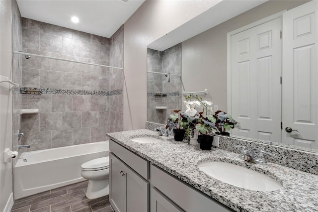 full bathroom with vanity, toilet, and tiled shower / bath