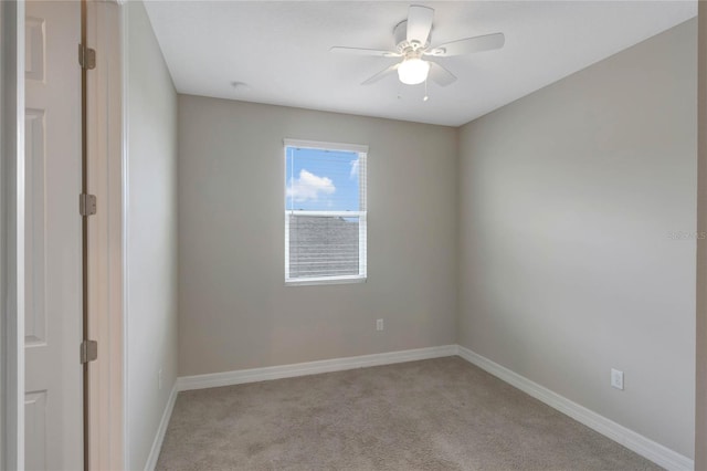 carpeted empty room featuring ceiling fan