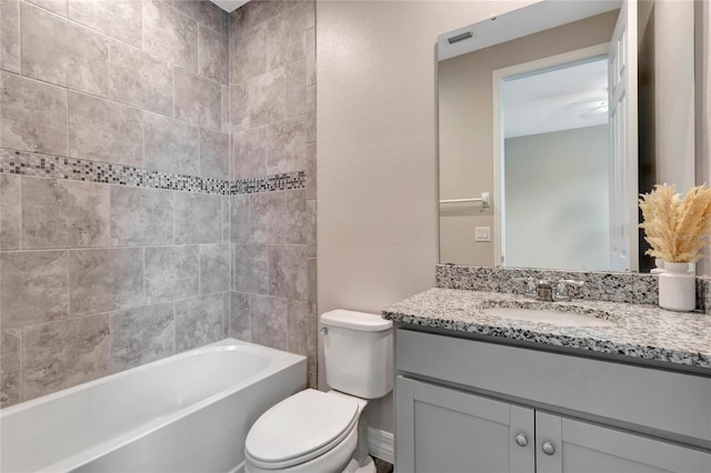 full bathroom with vanity, toilet, and tiled shower / bath