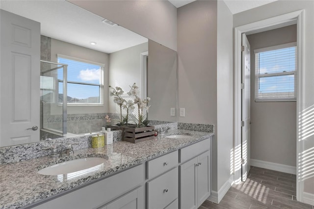 bathroom featuring vanity and an enclosed shower