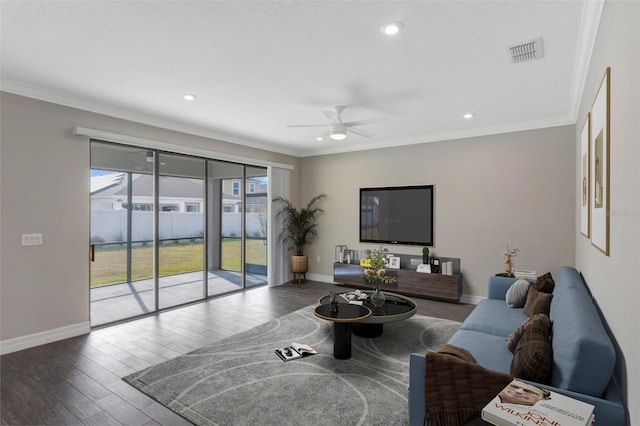 living room featuring hardwood / wood-style flooring, ceiling fan, and crown molding