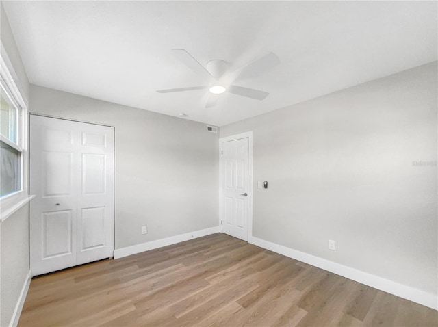 unfurnished bedroom with a closet, ceiling fan, and light hardwood / wood-style floors