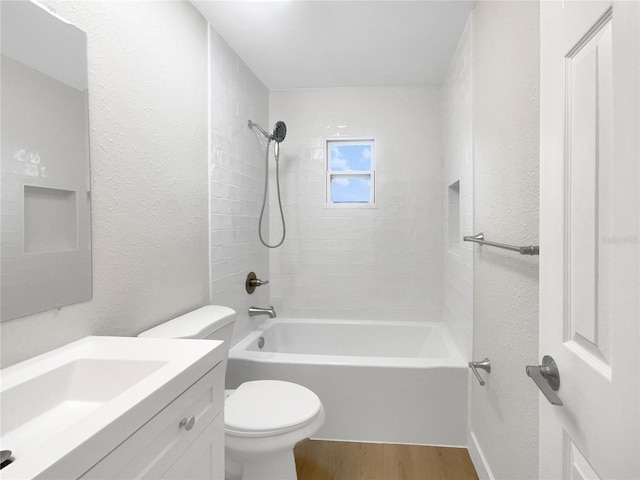 full bathroom with hardwood / wood-style flooring, vanity, toilet, and tiled shower / bath combo