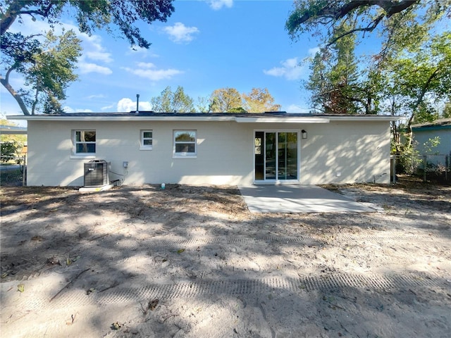 rear view of property featuring a patio and central air condition unit