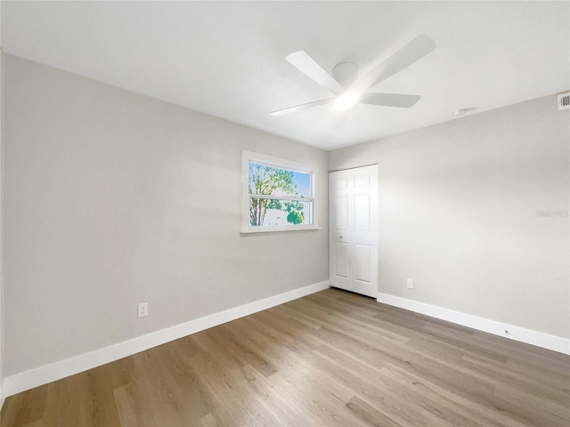 unfurnished room with ceiling fan and light wood-type flooring