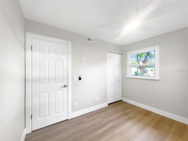 unfurnished bedroom featuring ceiling fan and light hardwood / wood-style floors