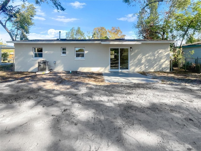 back of property featuring cooling unit and a patio