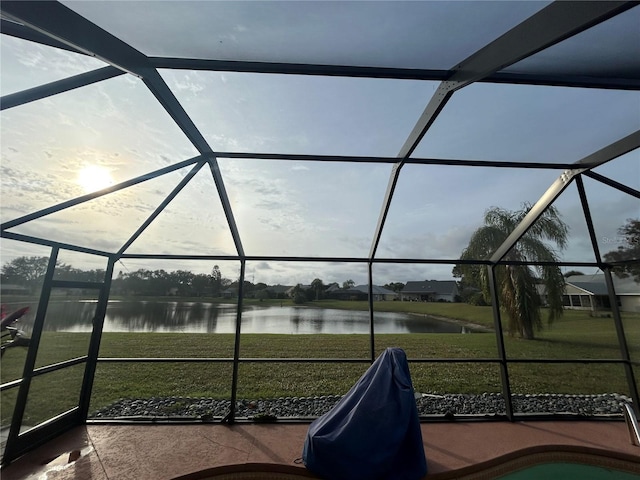unfurnished sunroom with a water view