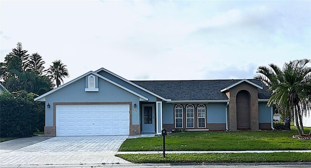 single story home featuring a garage and a front yard