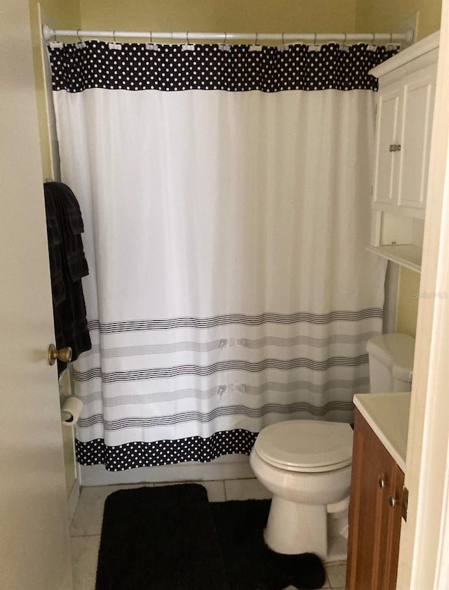 bathroom with tile patterned flooring, vanity, toilet, and a shower with shower curtain
