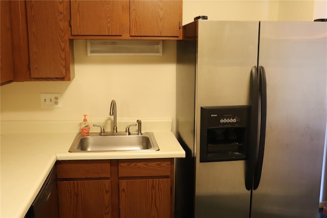 kitchen featuring stainless steel fridge, black dishwasher, and sink