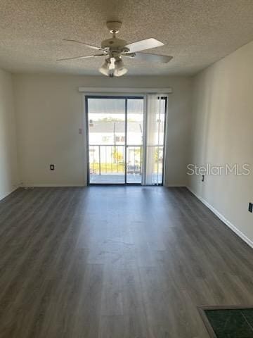 unfurnished room with a textured ceiling, ceiling fan, and dark wood-type flooring