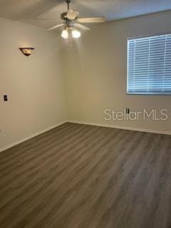 unfurnished room featuring ceiling fan and dark hardwood / wood-style floors