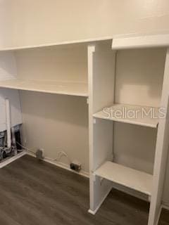 laundry area with dark hardwood / wood-style floors