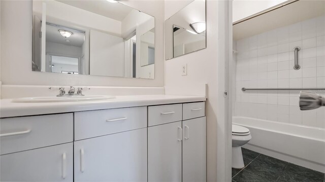 bathroom featuring toilet, tile patterned floors, and vanity