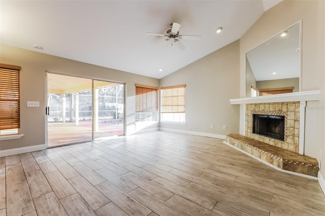 unfurnished living room featuring ceiling fan, a fireplace, and lofted ceiling