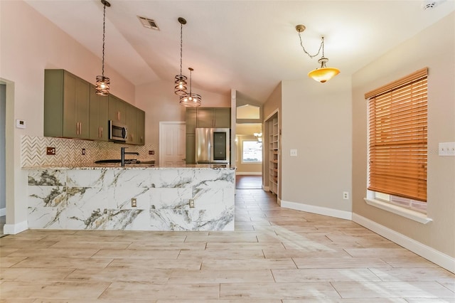 kitchen with light stone countertops, tasteful backsplash, stainless steel appliances, vaulted ceiling, and hanging light fixtures