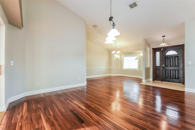 entrance foyer with hardwood / wood-style floors and an inviting chandelier