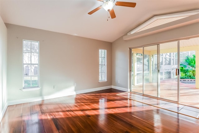 empty room with ceiling fan, lofted ceiling, and hardwood / wood-style flooring