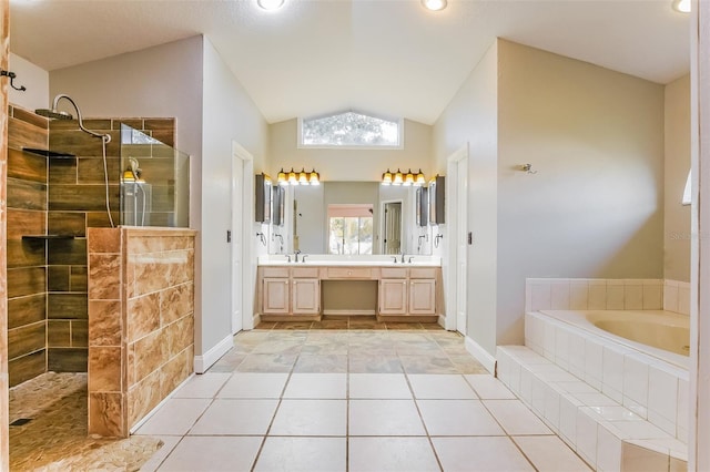 bathroom with tile patterned flooring, vanity, vaulted ceiling, and independent shower and bath