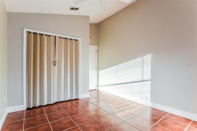 tiled spare room featuring ceiling fan and lofted ceiling