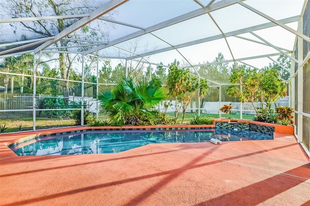 view of swimming pool featuring a lanai and a patio