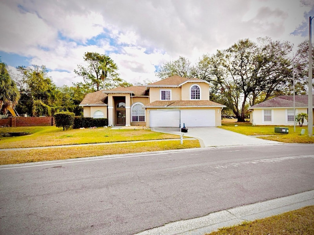 view of front facade with a front lawn and a garage