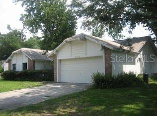 ranch-style house featuring a front yard and a garage