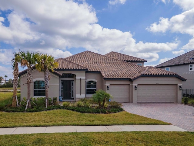 mediterranean / spanish-style house with a front lawn and a garage