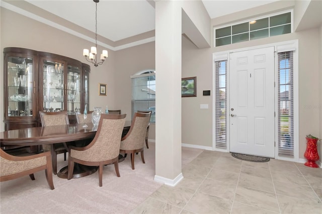 entrance foyer featuring an inviting chandelier, a healthy amount of sunlight, and light tile patterned flooring