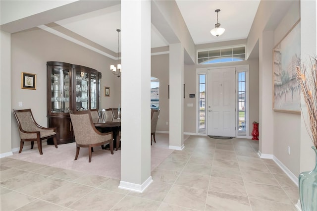 entryway with a notable chandelier and light tile patterned flooring