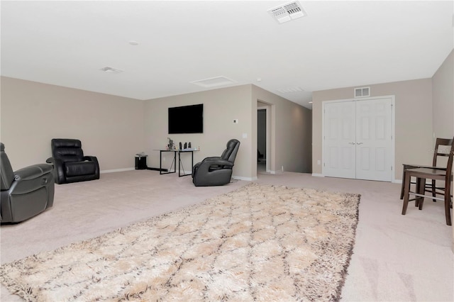 sitting room featuring light colored carpet