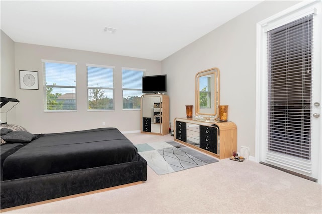 bedroom featuring light carpet