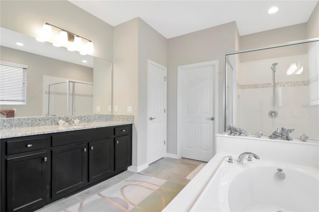 bathroom featuring independent shower and bath and vanity